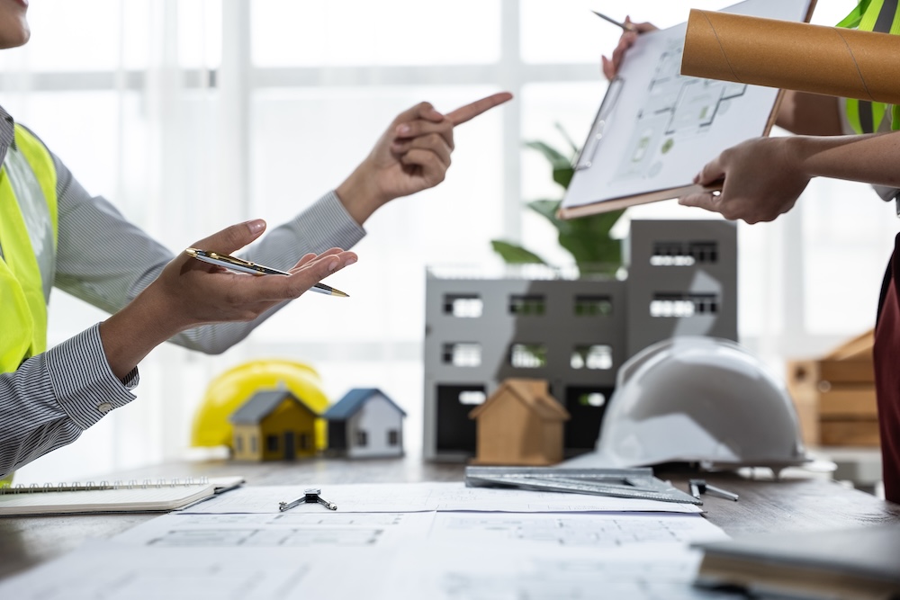 employees discussing blueprints